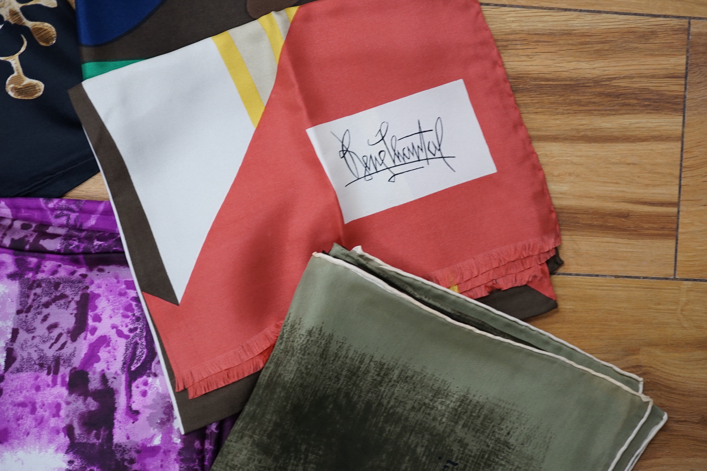 A collection of vintage silk scarves including Lanvin, Yves Saint Laurent, Maggy Rouff and one retailed by Harrods
